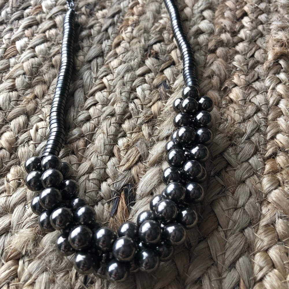 Silver tone necklace with beaded cluster.